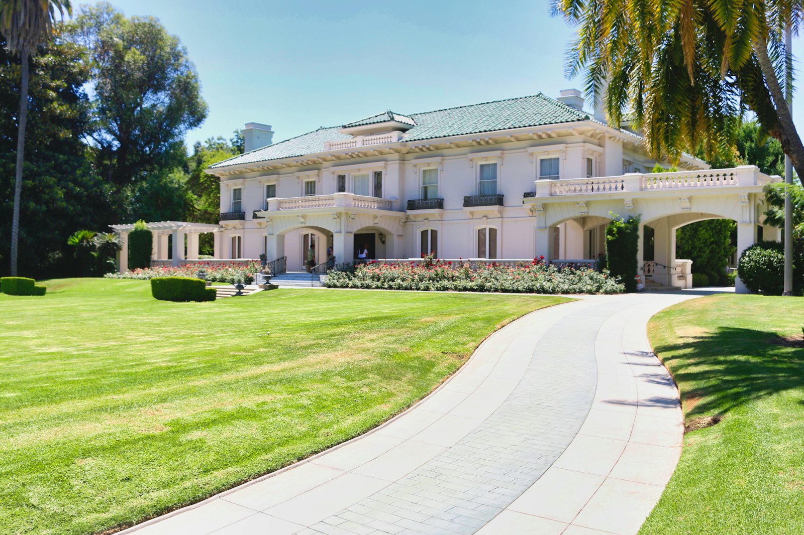 Estate home with a long clean driveway and manicured lawn