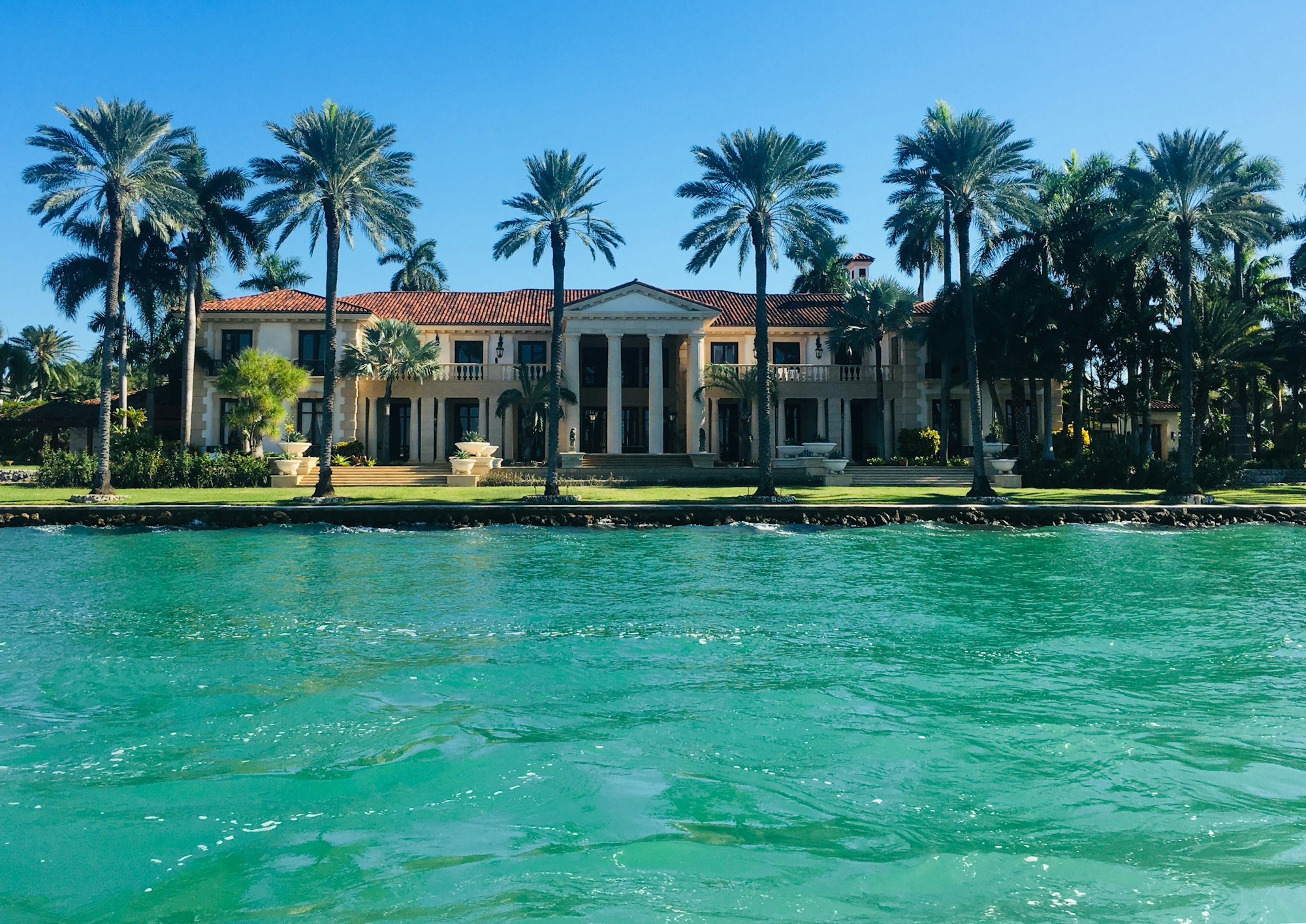 Waterfront South Florida estates lined with palms